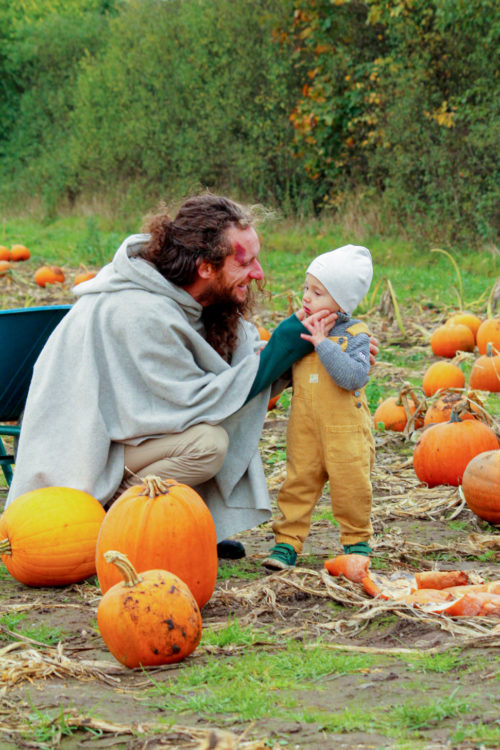 dad and son on a pumpkin field